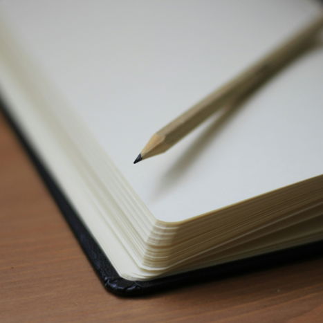 shallow focus photography of pencil on book